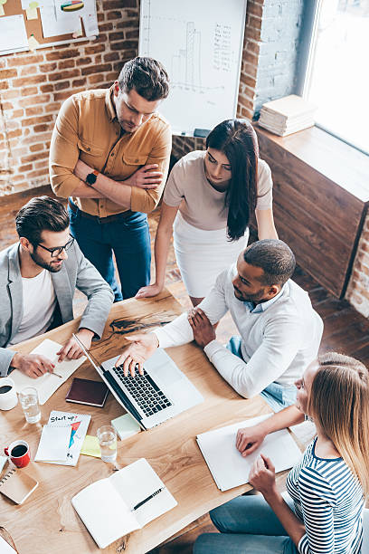 Employees of a web development and UI/UX design agency discuss a project